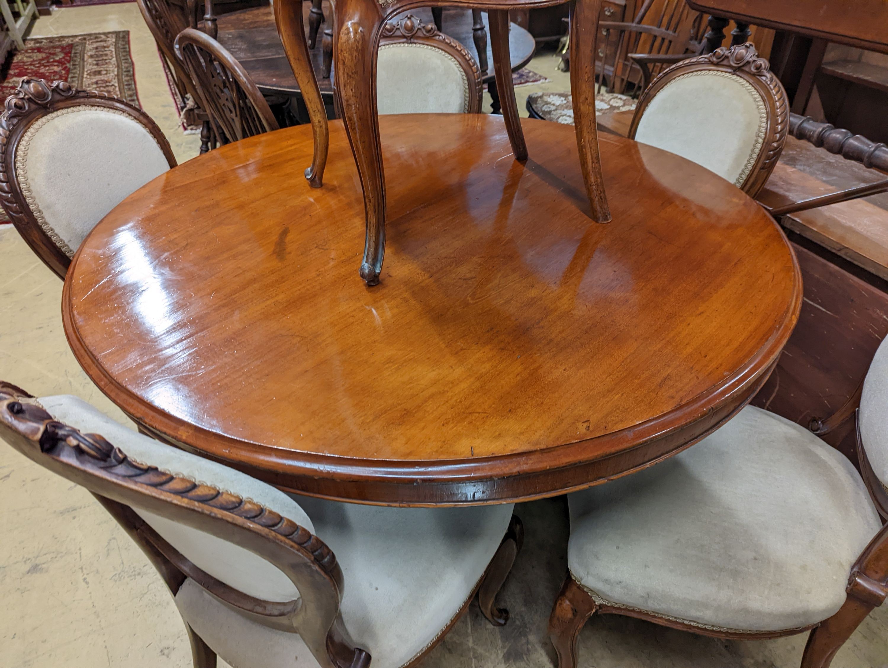 A set of six Victorian mahogany upholstered balloon back dining chairs together with a Victorian mahogany circular breakfast table, diameter 118cm, height 72cm